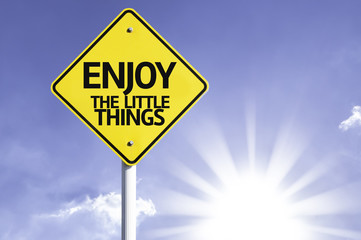 Enjoy the Little Things road sign with sun background