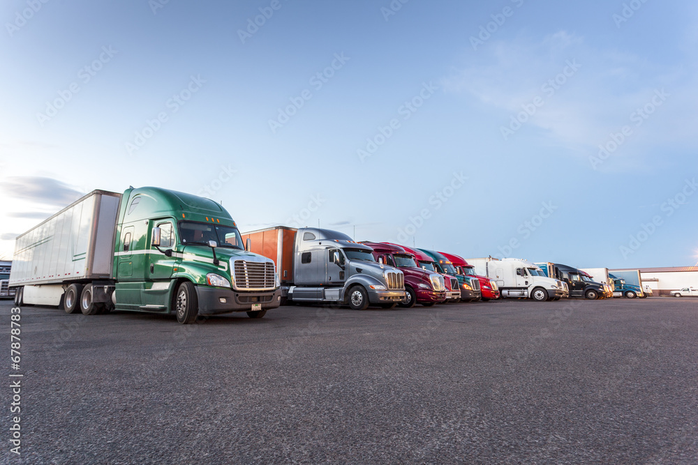 Wall mural many american trucks on parking lot.