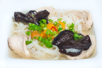 Homemade chicken soup with rice noodles