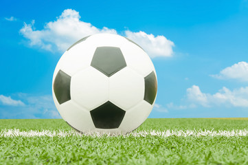 Soccer ball on the field with blue sky.