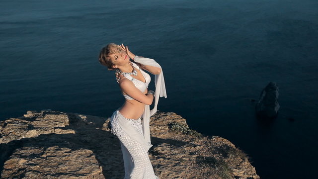 Girl masterly performs belly dancing beside an incredibly