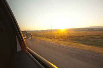 Obraz na płótnie Canvas Sunrise out the window of a moving vehicle.