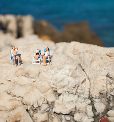 Miniature couple an a beach in swimming costume