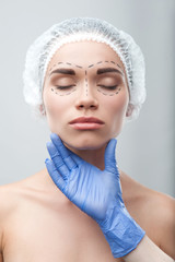 Beautiful young woman in surgical cap with perforation lines on