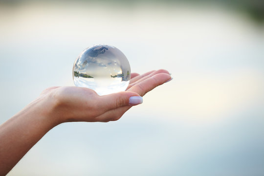Crystal ball on hand - Powered by Adobe