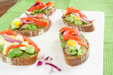 Brown bread with avocado, smoked salmon, boiled egg