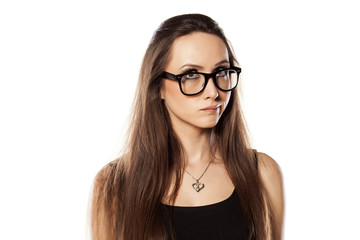 Fototapeta premium unsure young woman is thinking and looking up