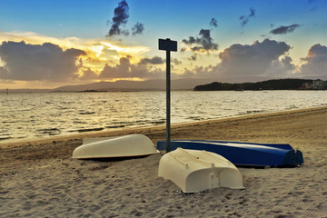 Overturned boats on the beach © Arousa