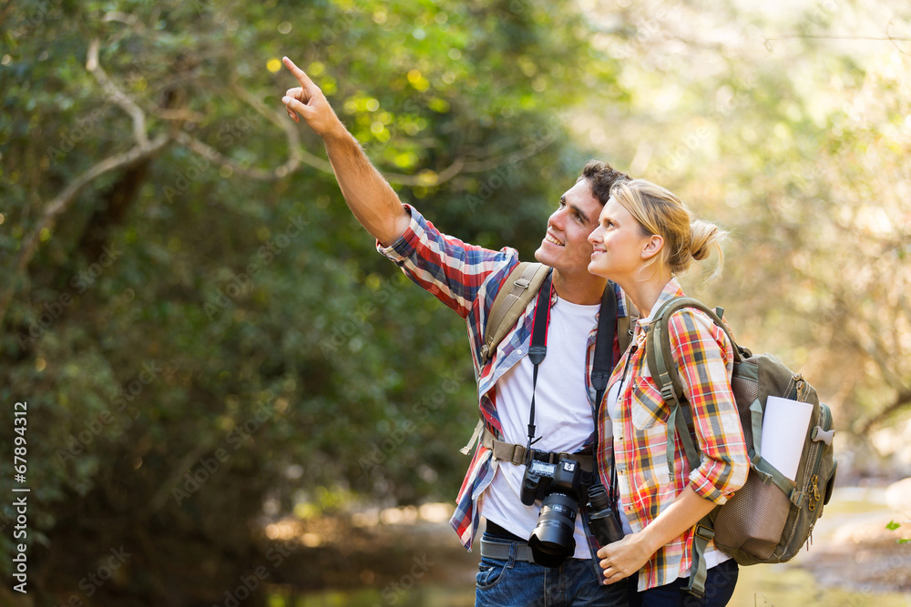 Wall mural young couple hikers in mountain