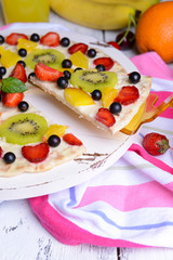 Sweet pizza with fruits on table close-up