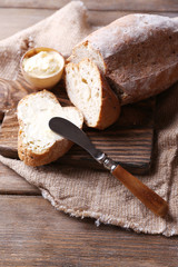 Fresh bread and homemade butter on wooden background