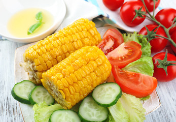 Grilled corn cobs on table, close-up