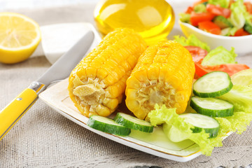 Grilled corn cobs on table, close-up