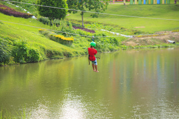 young boy sliding in adventure park