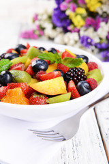 Delicious fruits salad in plate on table close-up