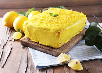Tasty lemon cake on wooden table