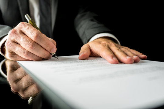 Businessman signing a paper document
