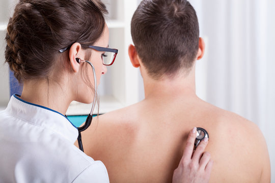 Doctor Examining Patient Lungs