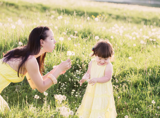 Mother and daughter with dandelions