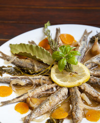 Tasty Marinated sardines on white plate with Mediterranean