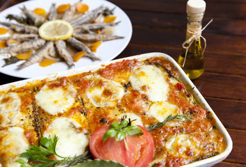 Melanzane alla Parmigiana and Marinated sardines in background