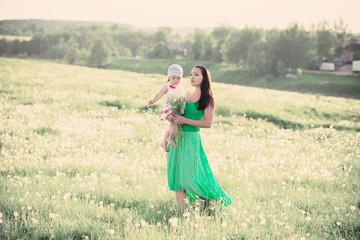 Fototapeta na wymiar happy mother holding baby outdoor