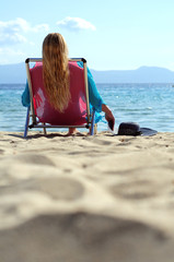 Fototapeta premium Woman lying deck chair beach