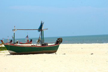 Naklejka na ściany i meble Fishing boat the sand sea beach.