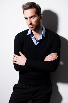 Fashion portrait of young man in black pullover.
