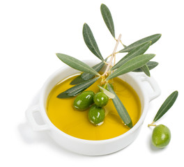small bowl with olive oil, decorated with a small twig with gree