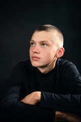Close-up of the young man in the black clothes, smiling