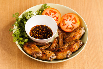 Grilled chicken wings on dish.