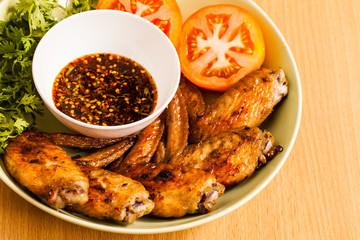 Grilled chicken wings on dish.