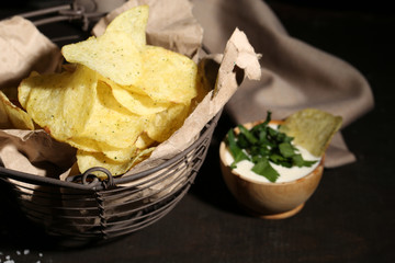 Tasty potato chips in metal basket