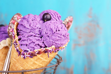 Tasty ice cream with berries in waffle cones
