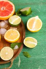 Different sliced juicy citrus fruits with ice