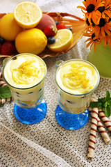 Tasty lemon desserts on table at home