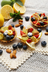 Tasty lemon desserts on table at home