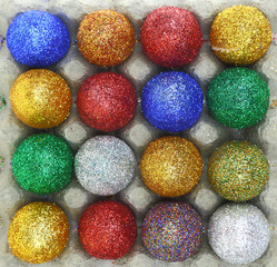 Colorful glitter eggs in carton egg packaging