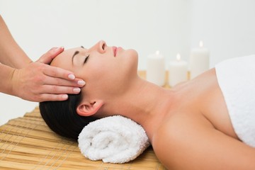 Obraz na płótnie Canvas Peaceful brunette enjoying a facial massage