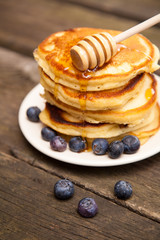 Delicious pancakes with blueberry and honey
