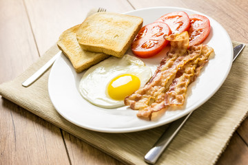 English Breakfast With Fried Egg, Toast, Bacon And Tomatoes