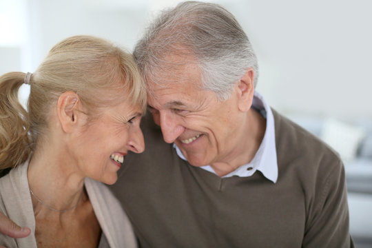 Cheerful senior couple looking at each other's eyes