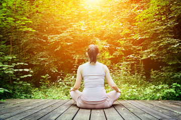 Young woman meditating in a forest. Zen, meditation, breathing