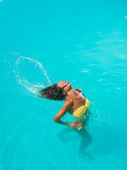A girl is relaxing in a swimming pool