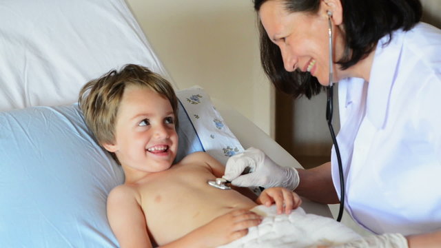 Doctor consulting a cute funny boy