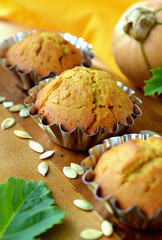 Sweet pumpkin muffins in metal molds .