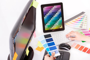 Graphic designer at work. Color samples.
