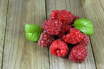 heap of raspberries on wooden background