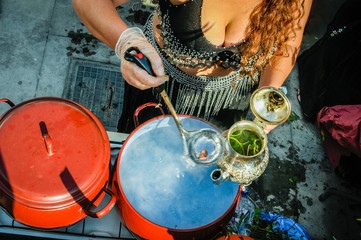Fototapeta na wymiar Woman making herbal tea or infusion in andalusi festival